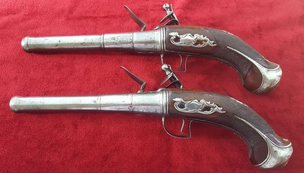 A fine pair of Queen Anne style flintlock pistols by Bennett of London. Finely worked mounts. C1790. Good condition. Ref 9382.